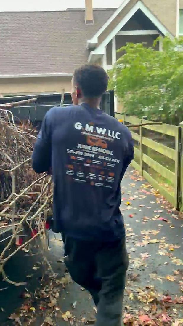G.M.W crew member hauling brush to the trailer
