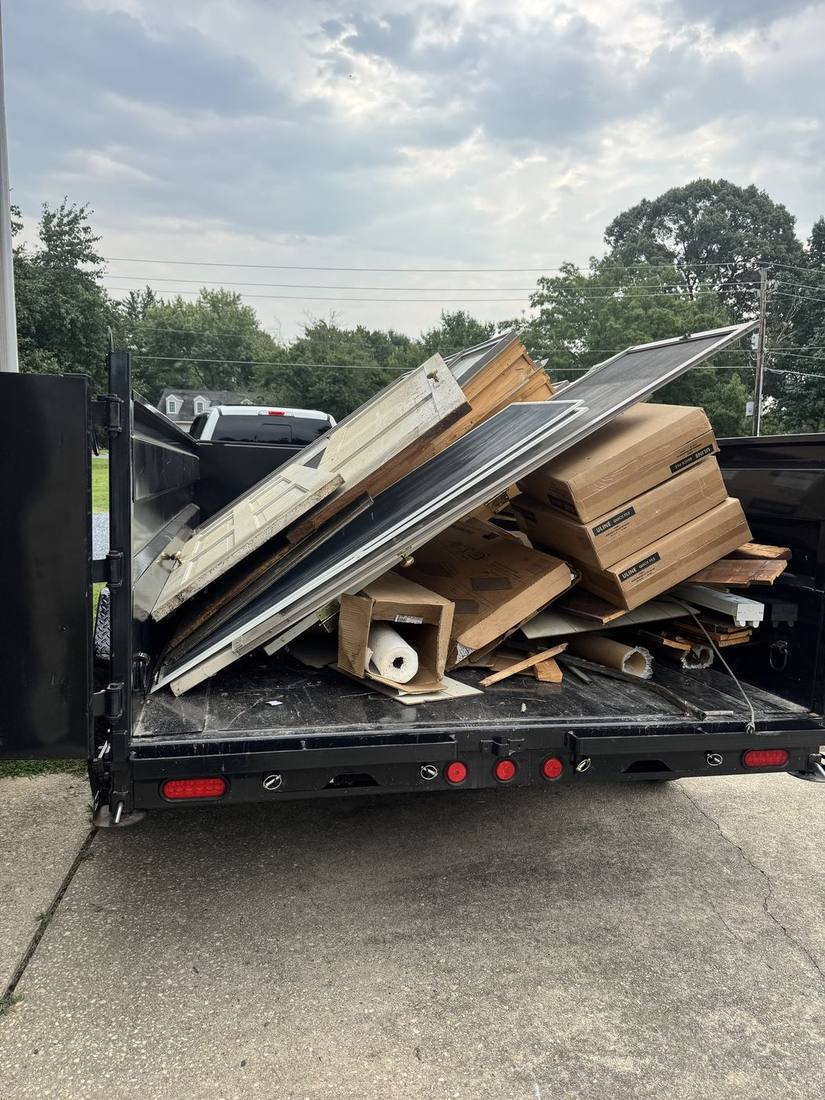 G.M.W dump trailer loaded with doors and renovation debris